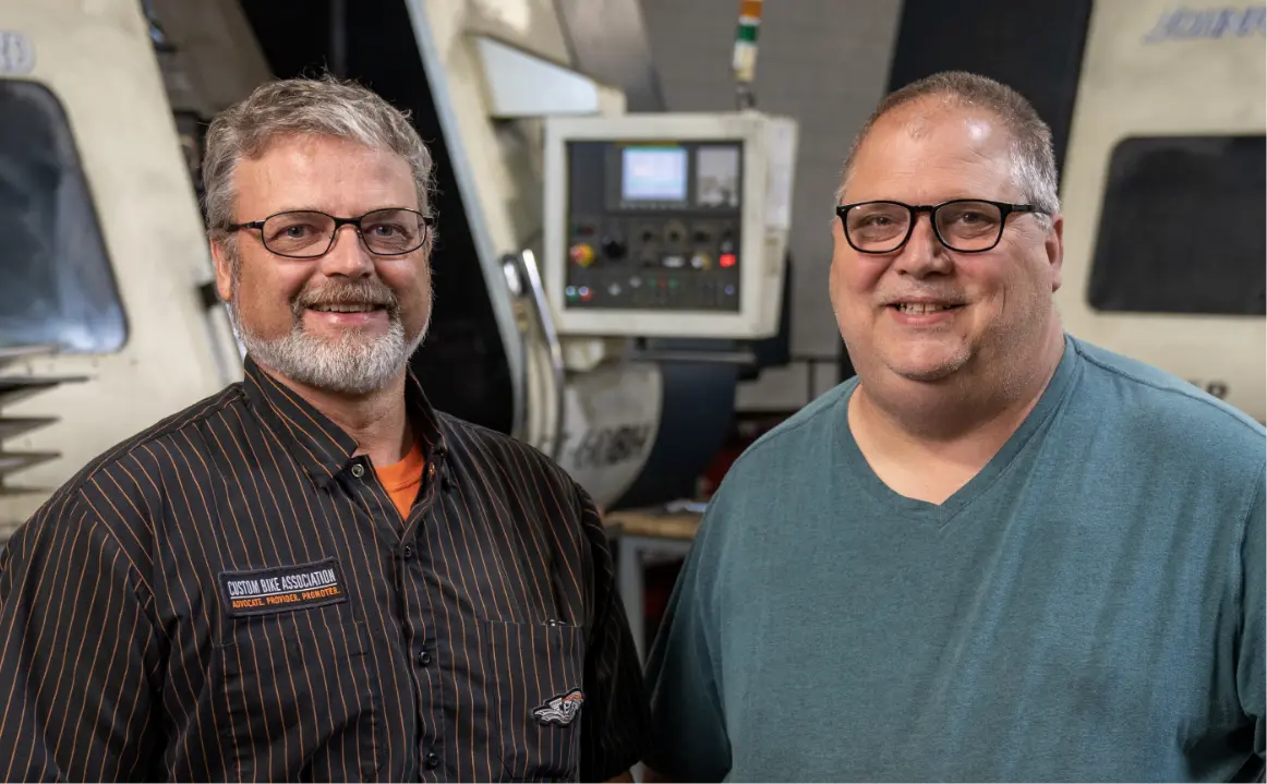 male employees in front of machine